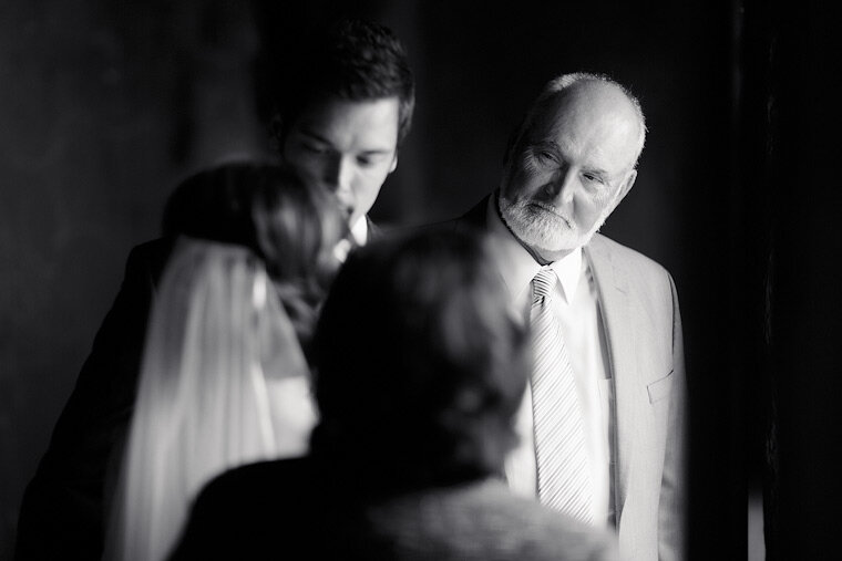Bride's father smiles at her during formals.