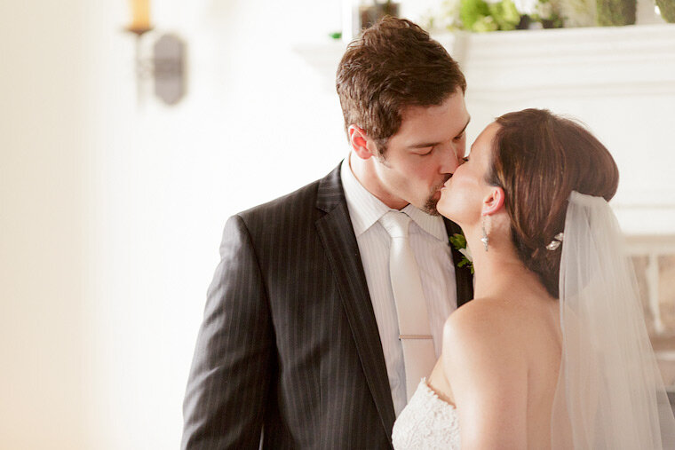 Bride and groom kiss.