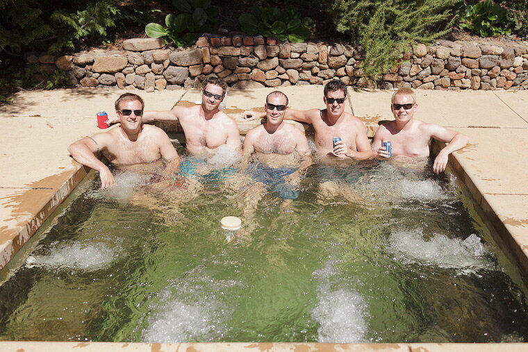 Groomsmen in hot tub before wedding.