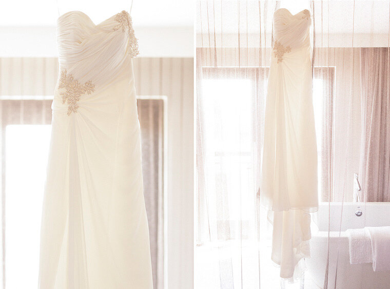 Bride's dress hanging in window.