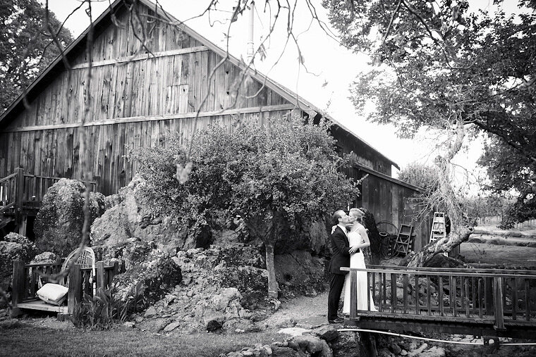 Bride and groom near barn.