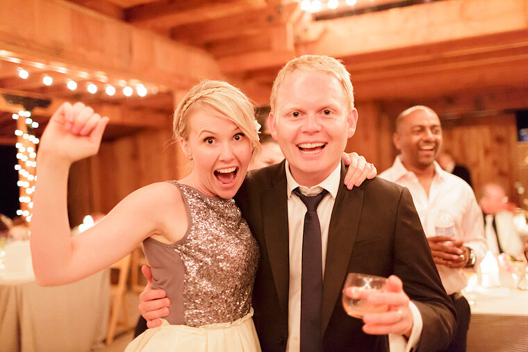 Groomsman and girlfriend at a barn wedding.