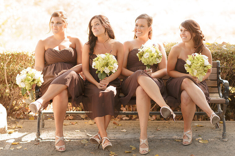 Bridesmaids looking on and smiling.