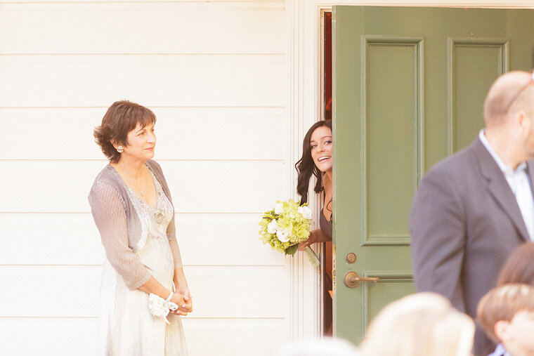 Bridesmaid peeks out the door to see who's ready.