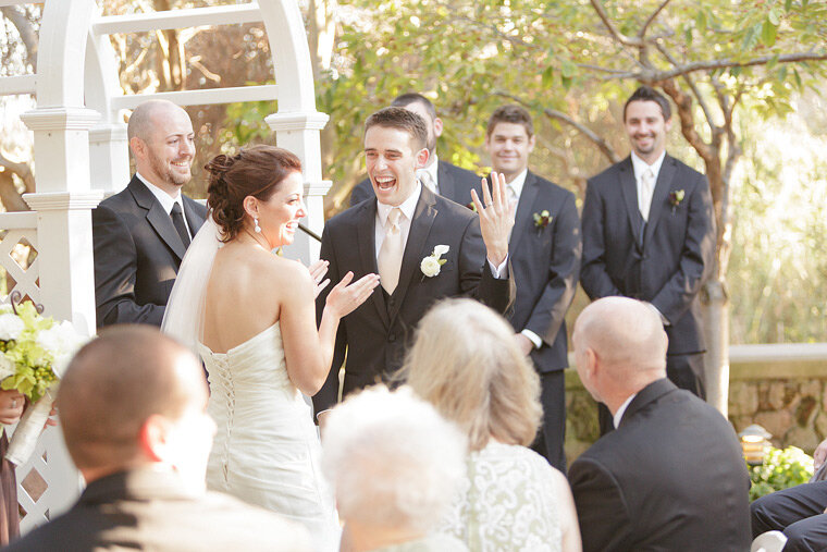 Bride and groom laugh during ceremony.