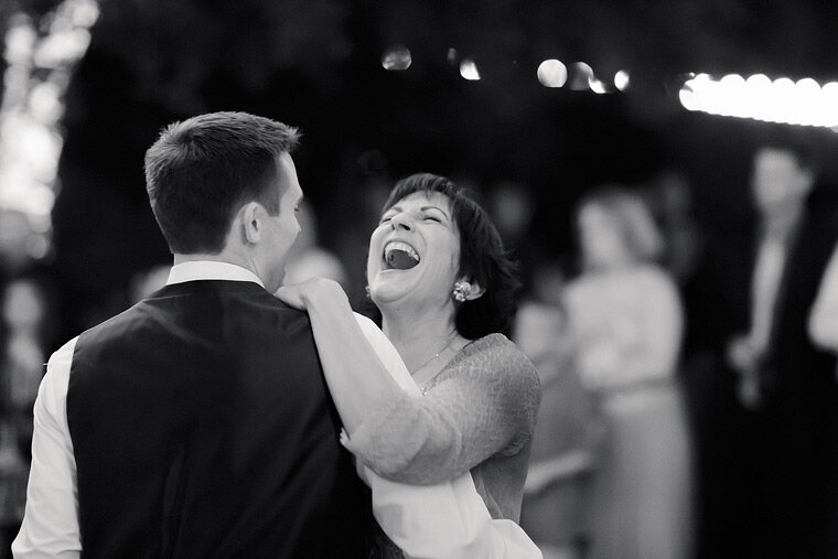 Mother of groom laughing and dancing.