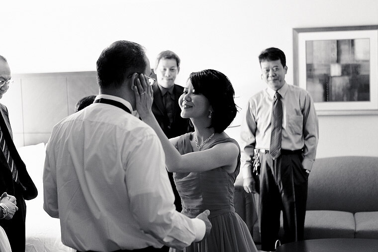 Bride smiles and touches groom's face