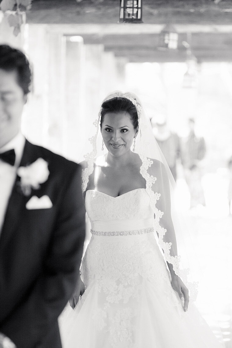 Bride walks up behind groom during a first-look.