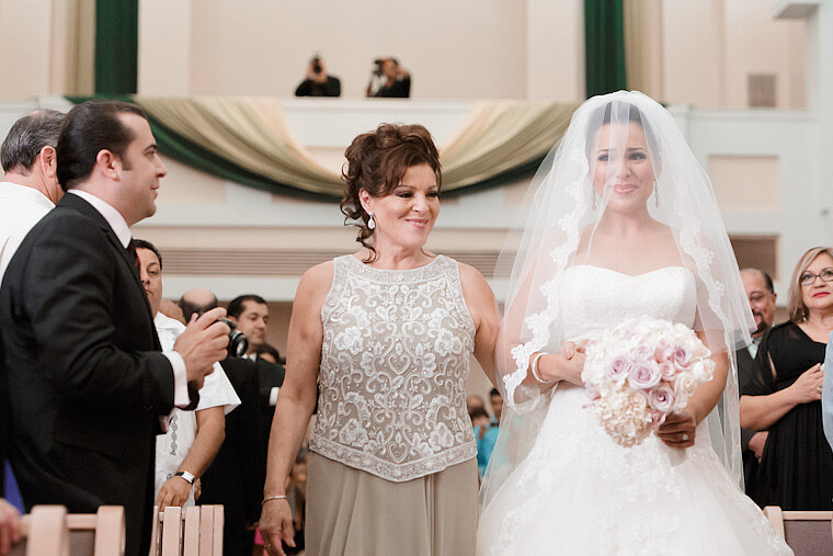 Bride and mother walk up the aisle at the processional.