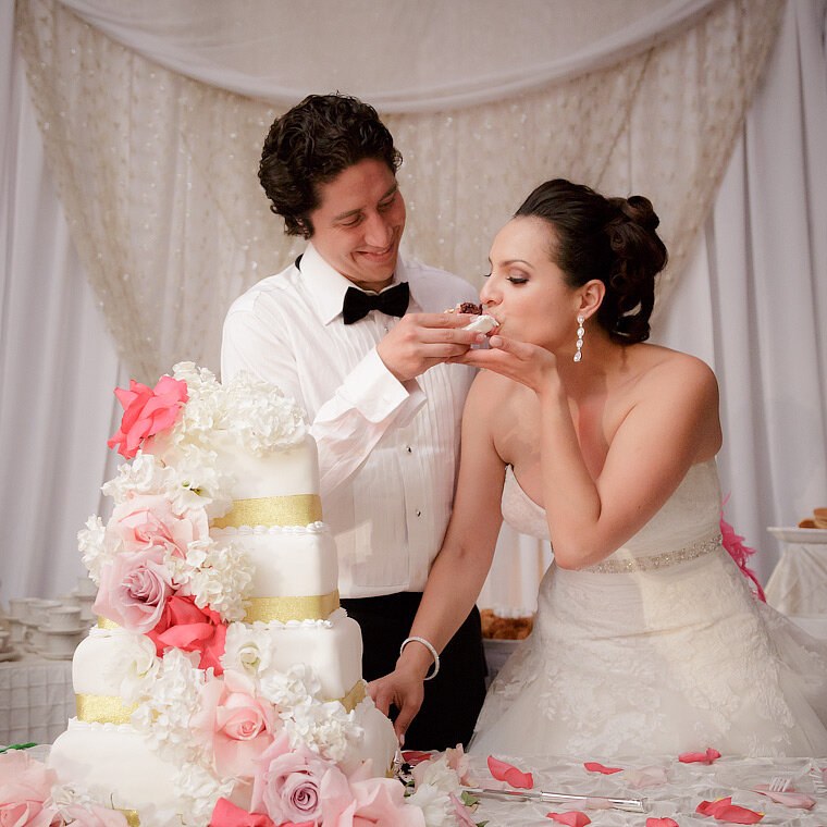 Bride takes a bite of cake at the reception.