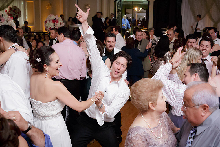 Groom dances with bride at reception.
