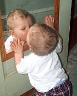 Baby experimenting with a mirror