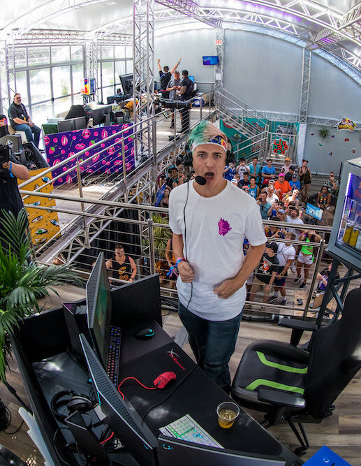 Ninja Tyler Blevins standing and yelling by his gaming rig at Lollapalooza Festival 2019