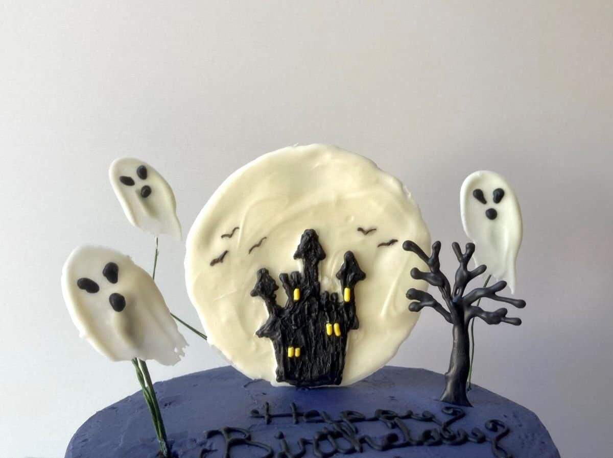 Close up of the Scooby Doo haunted castle cake of the chocolate moon, castle and flying chocolate ghosts.