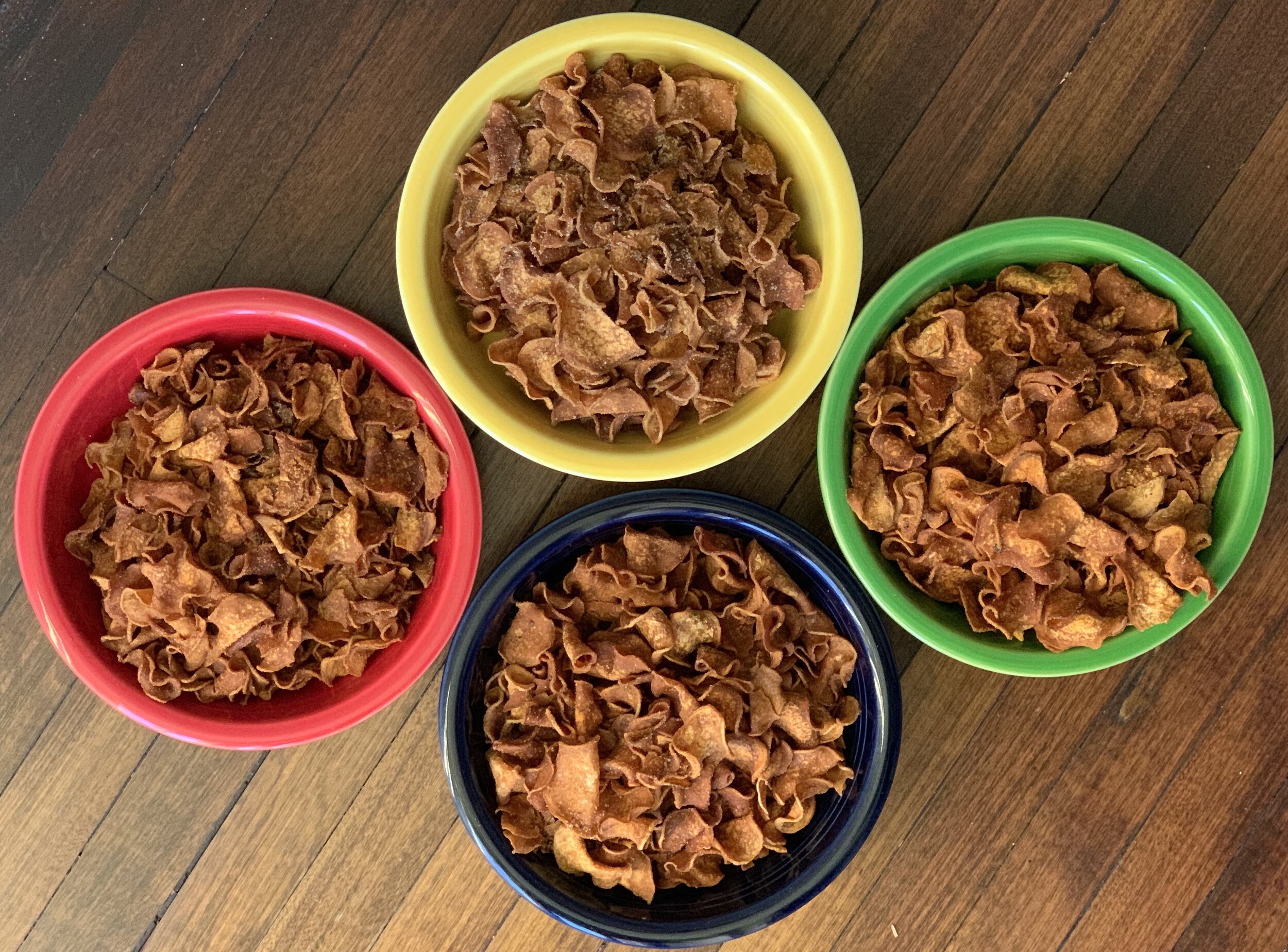 four bowls of mushroom-based vegan bacon chips