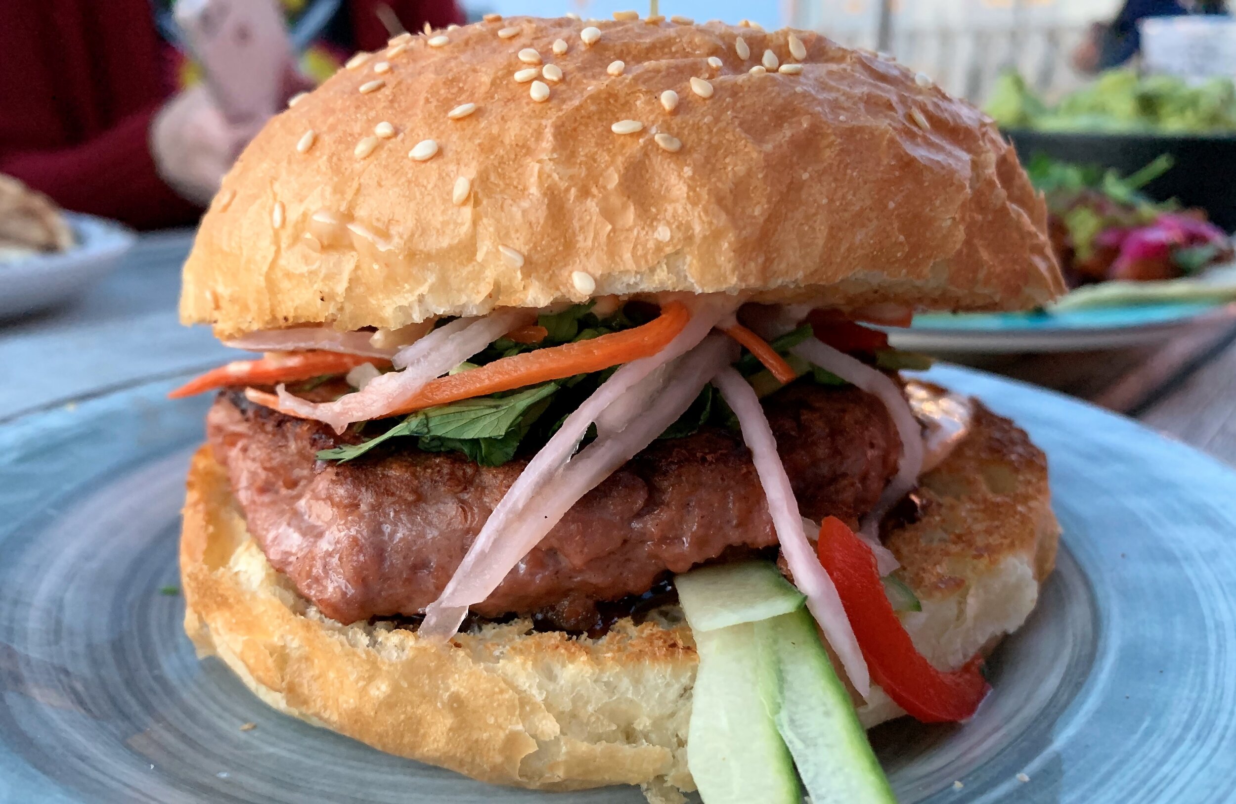 a vegan beyond burger made in the style of a banh mi on a bun