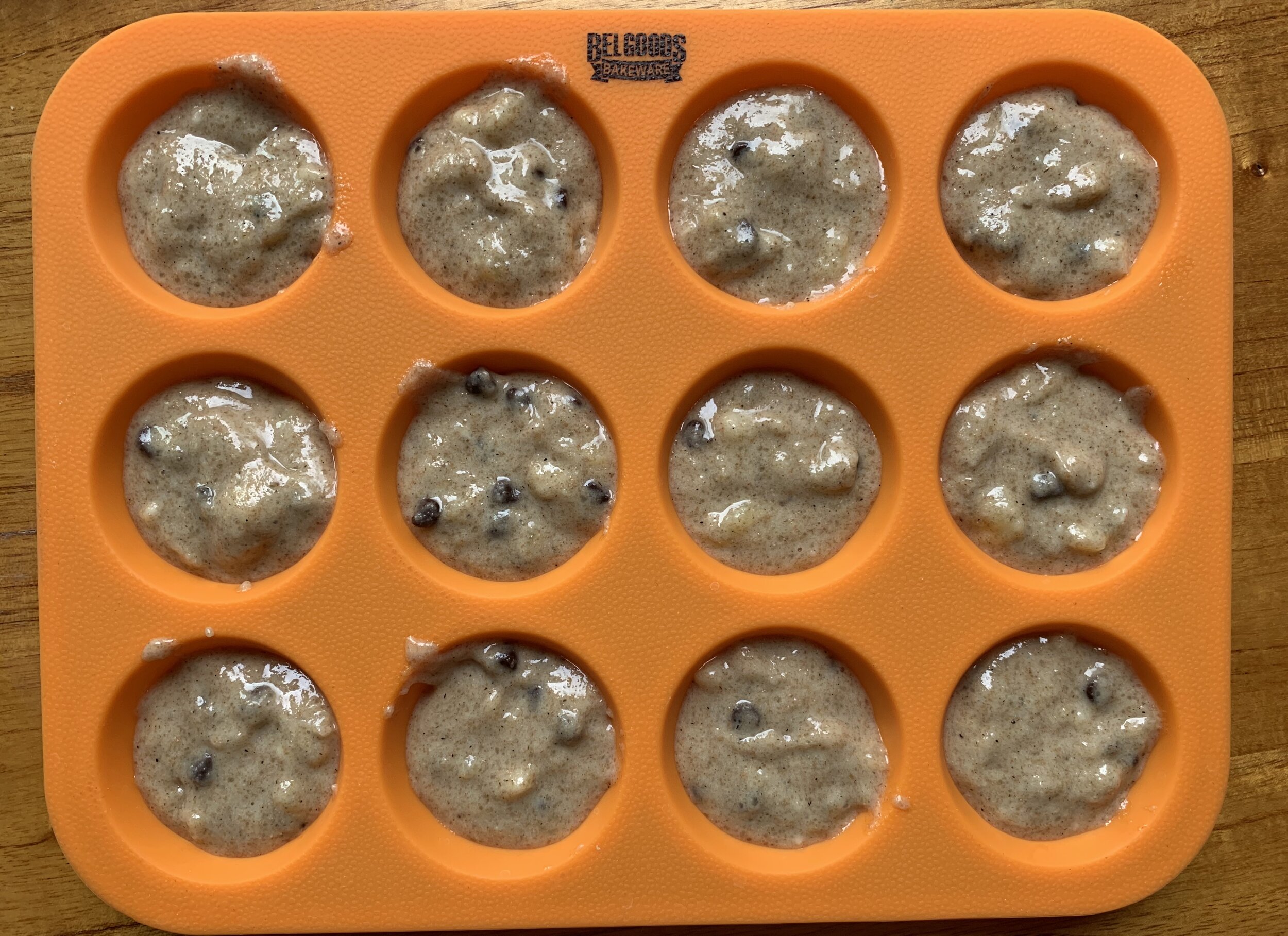 prepared muffin mix in a twelve count mini muffin silicon pan