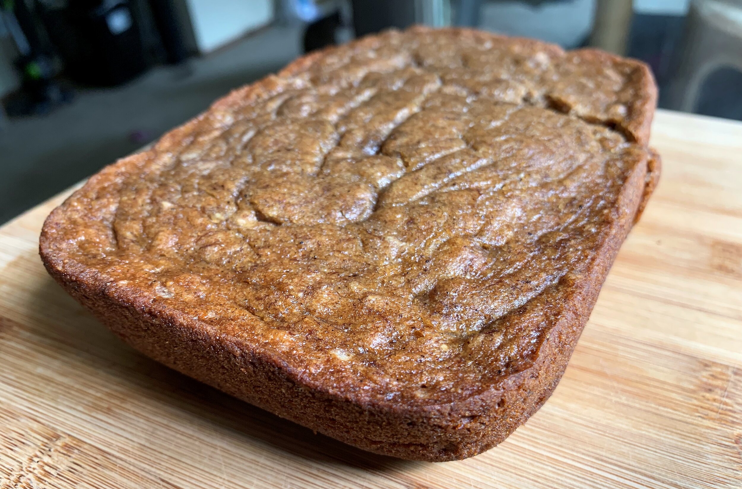 a loaf of vegan banana bread on a wooden board