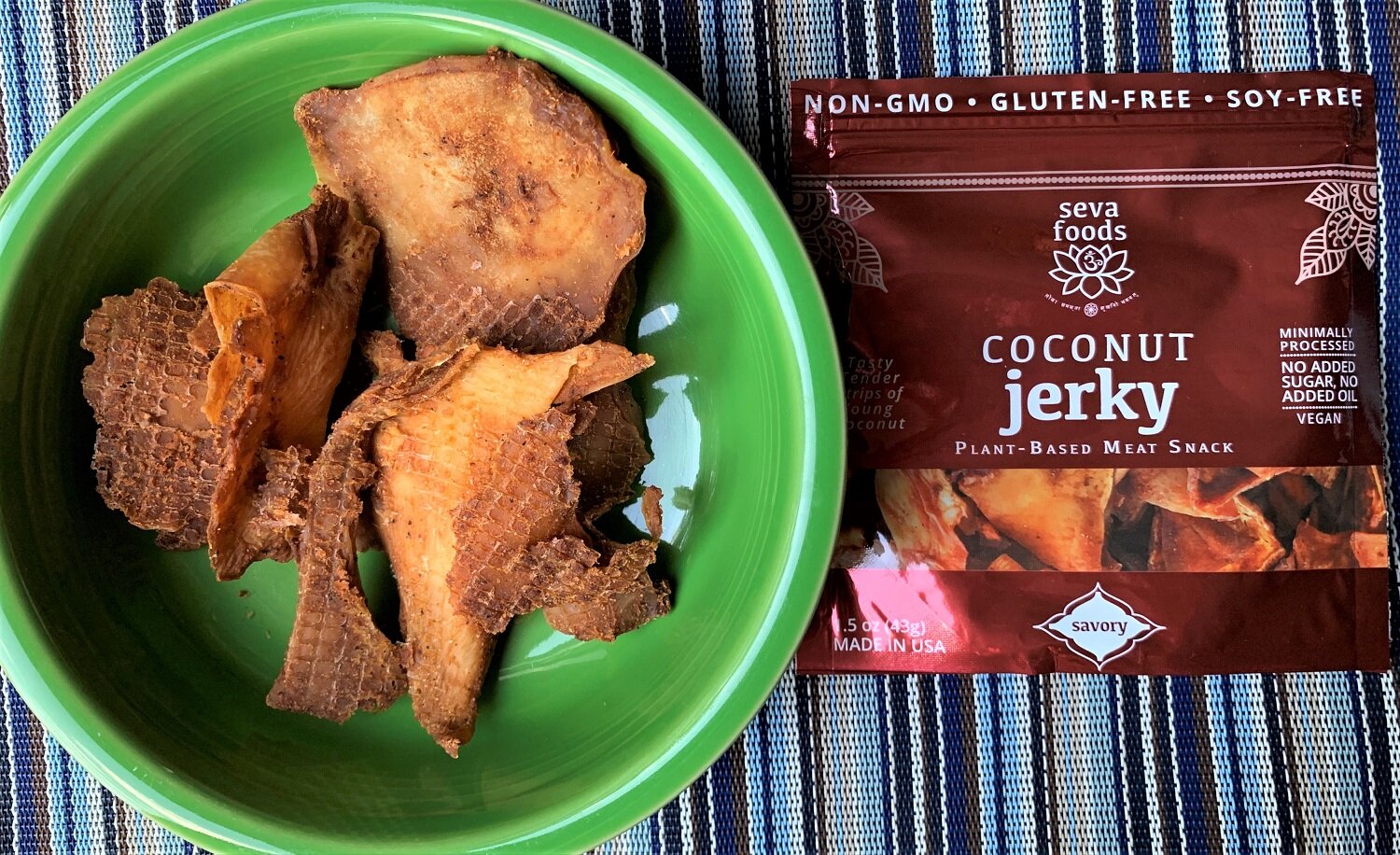 a bowl of coconut jerky with the product bag next to it