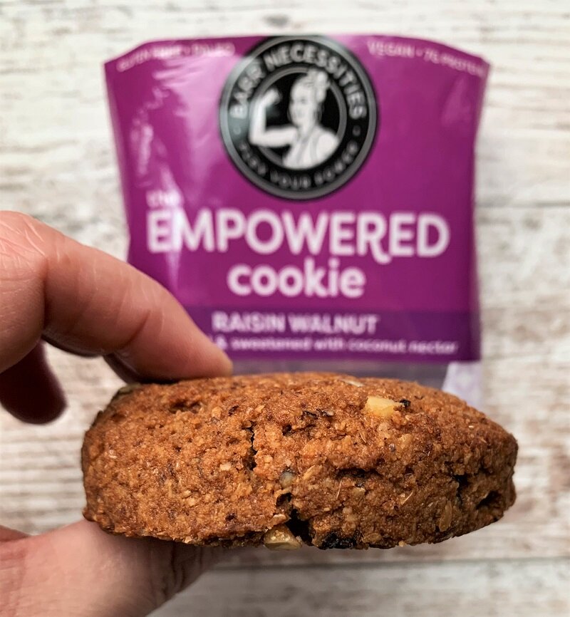 side view of a cookie with Empowered Cookie packaging in the background