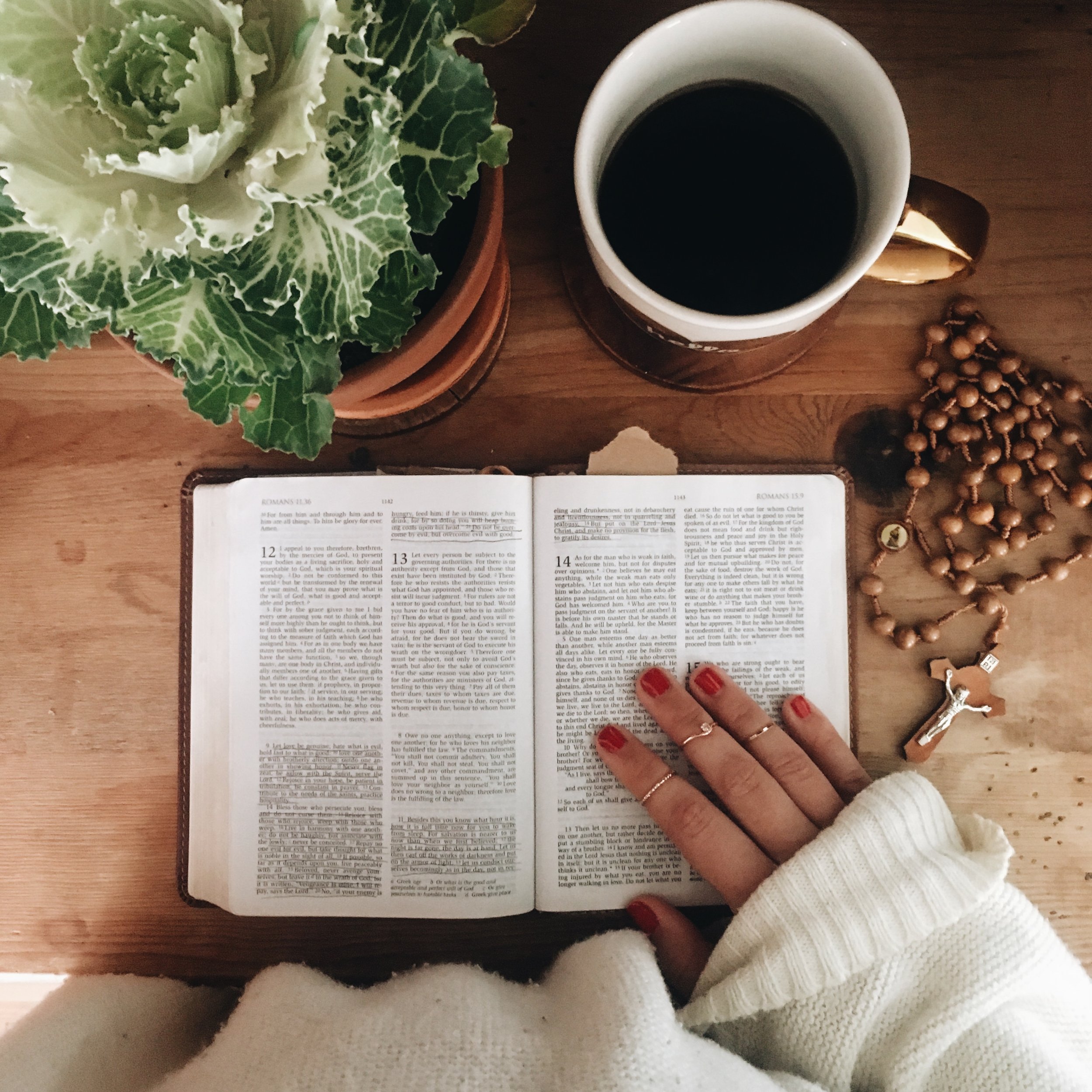 bible flatlay with coffee & rosary