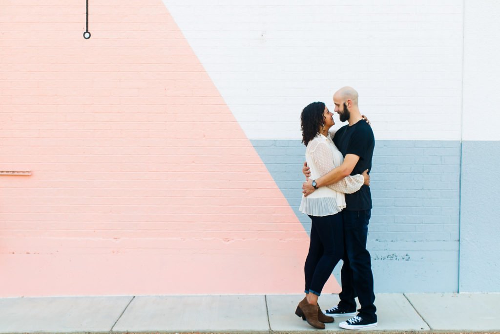 Hilary & Brian embracing on the sidewalk at their Fort Worth engagement session.