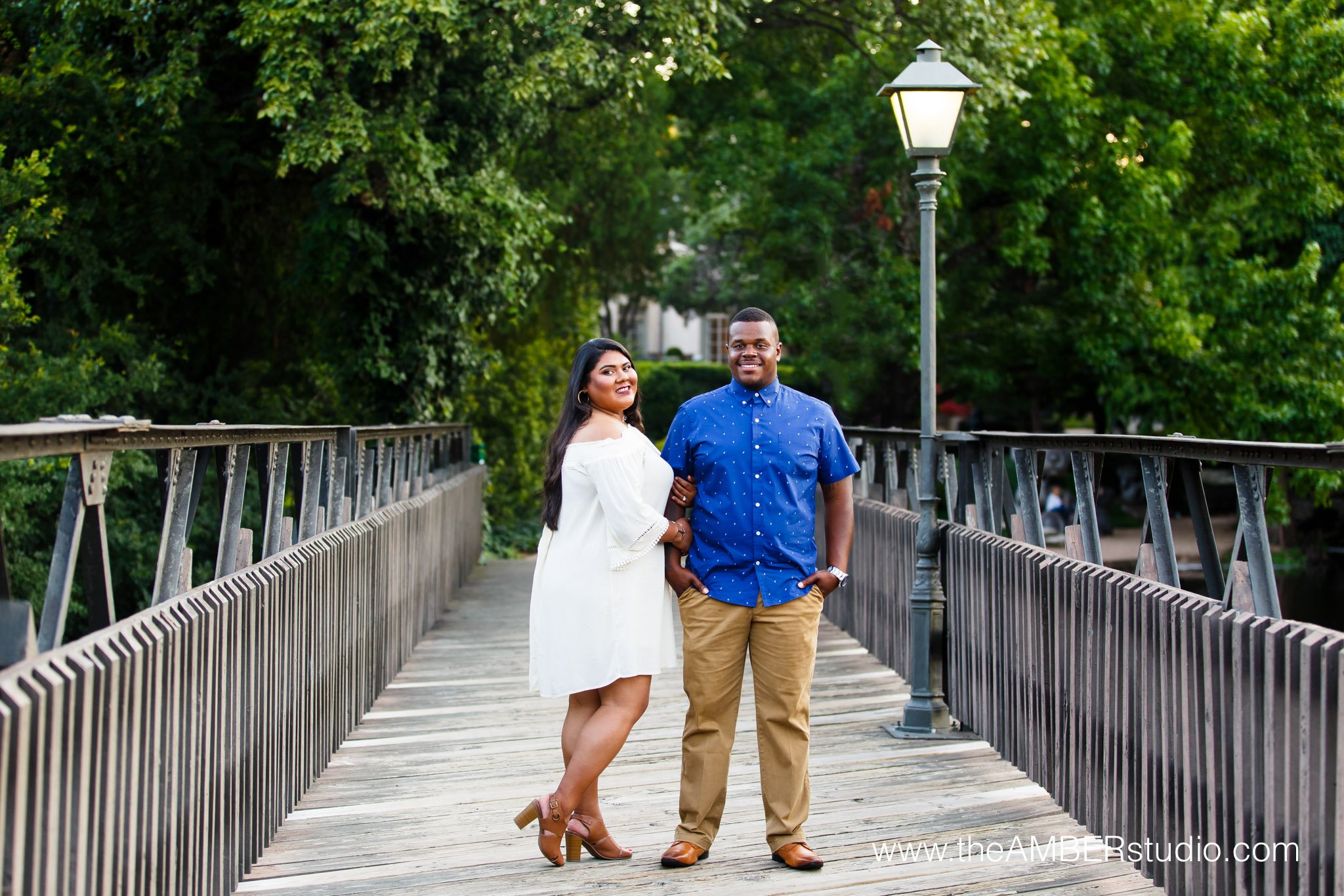 Interracial couple at their Dallas engagement session at Lakeside Park on the bridge.