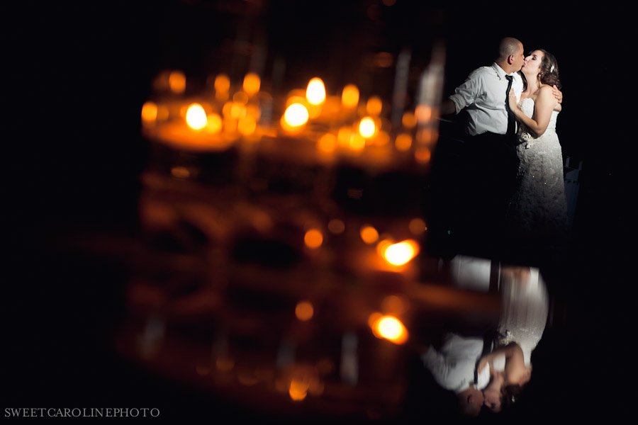 bride and groom reflection shot through candels