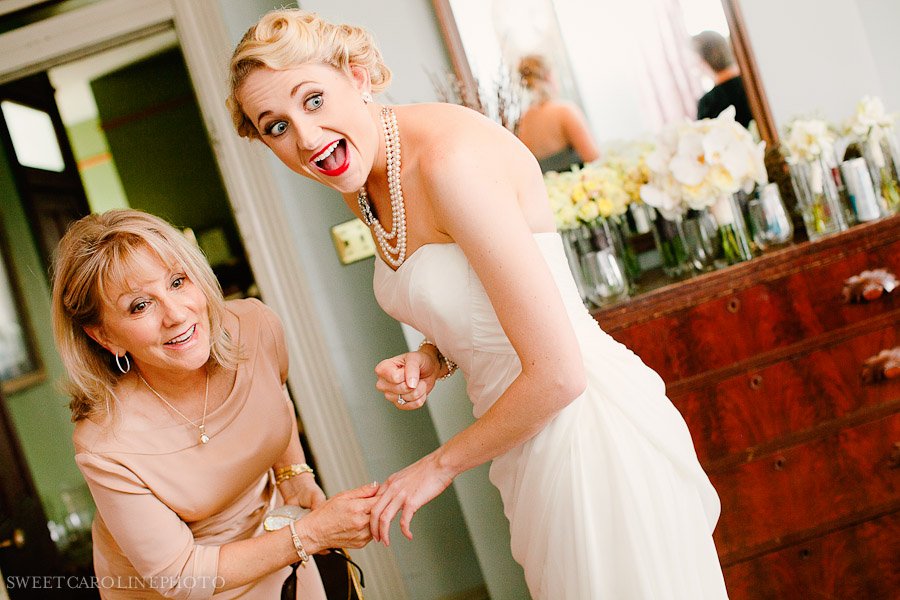 bride and guest smiling in getting ready room