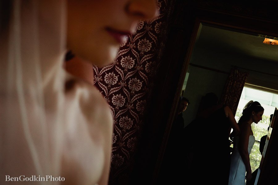 bride looking into the mirror getting ready for her wedding at barr mansion