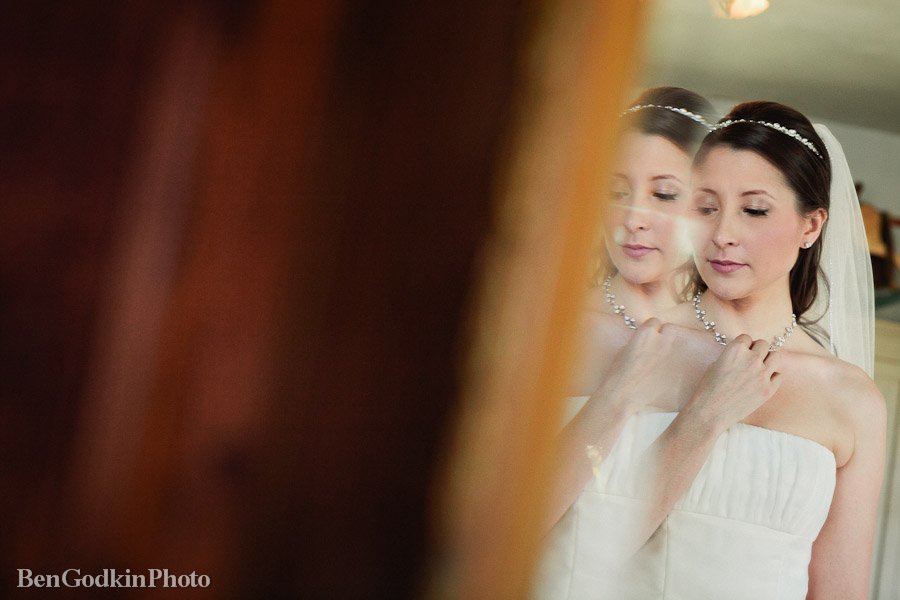 bride looking into the mirror getting ready for her wedding at barr mansion