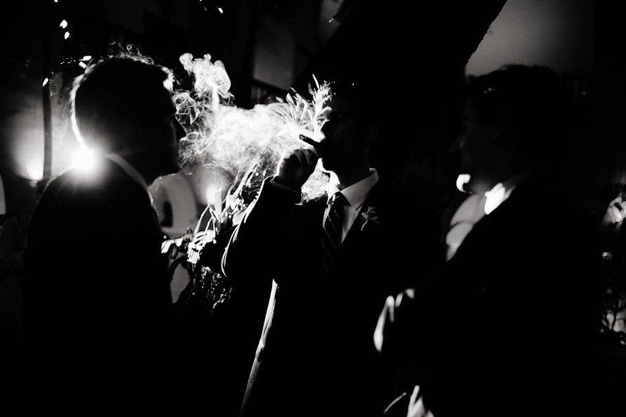 groom smoking cigar at Puerto Rican wedding