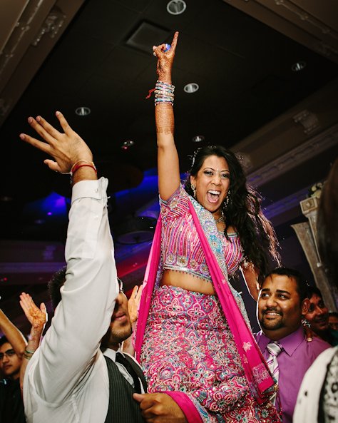 bride in pink sari at wedding reception