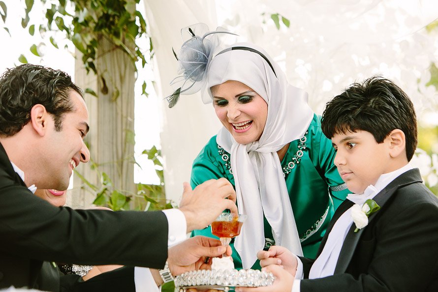 groom feeding the bride honey during persian ceremony