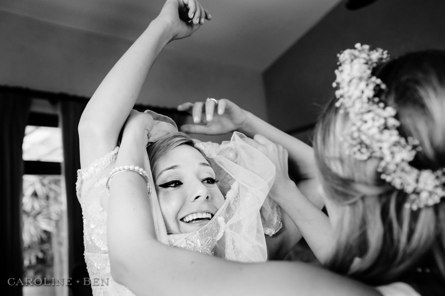 bride putting on dress flor de cabrera