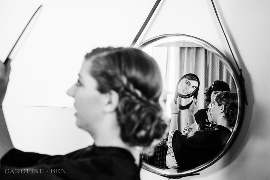 bride getting ready looking into mirror at double tree