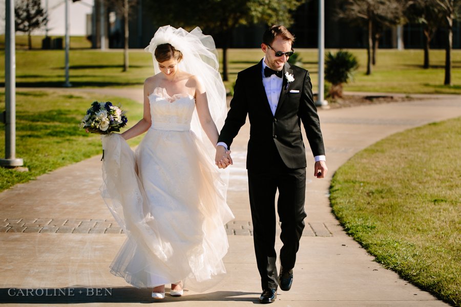 bride and groom walking at the park