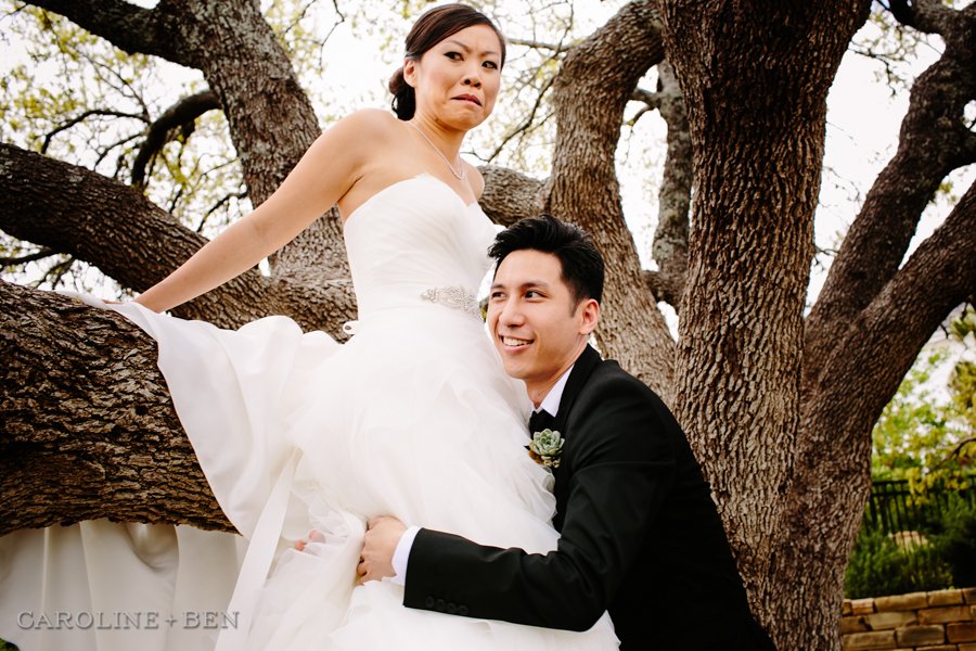 bride and groom climbing into tree
