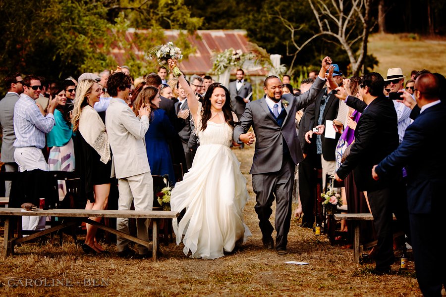 bride and groom walking down aisle during outdoor ceremony