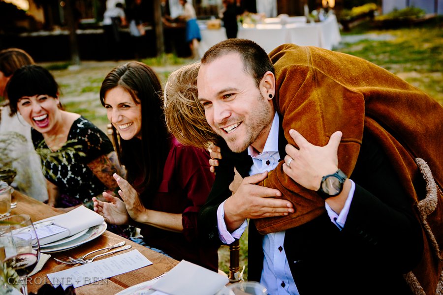 wedding guests hugging at outdoor reception