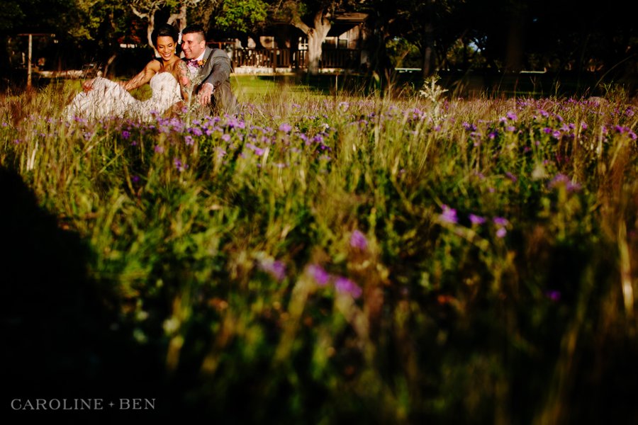 bride in groom in field of purple flowers