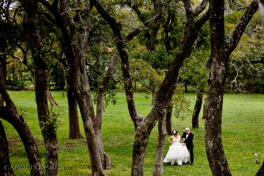 groom helping bride walking forest at winfield inn