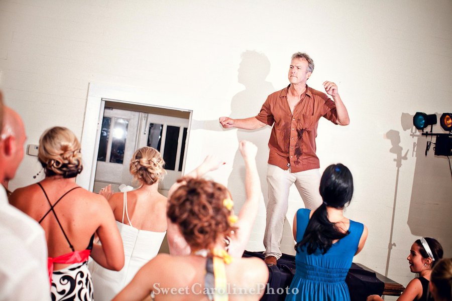 father on table dancing during reception