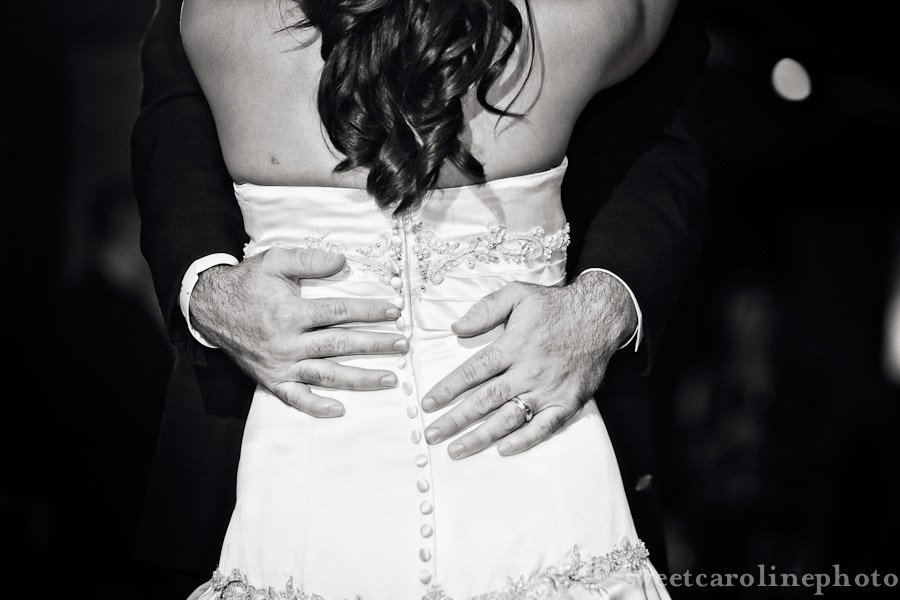 groom's hands on bride's hips during the first dance at Houston Wedding