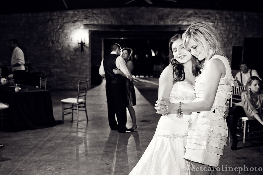 bride and mother dancing at end of night by Houston Wedding Photographer
