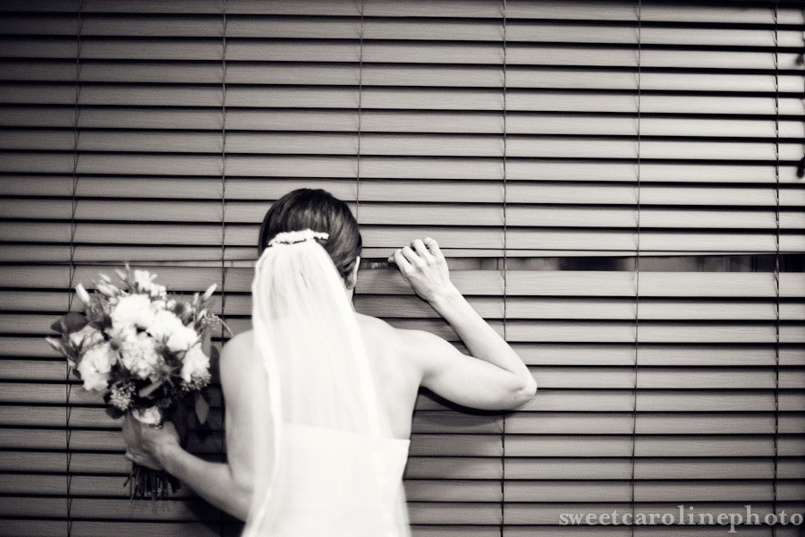 bride peeking out of blinds at Caovenant United methodist church