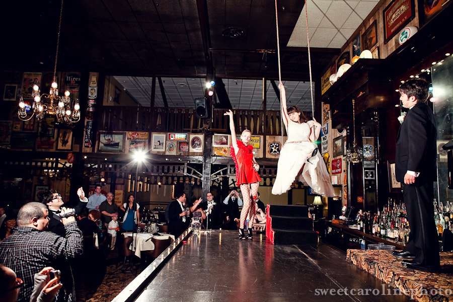 bride and groom on stage swinging at Old San Francisco Steakhouse in San Antonio