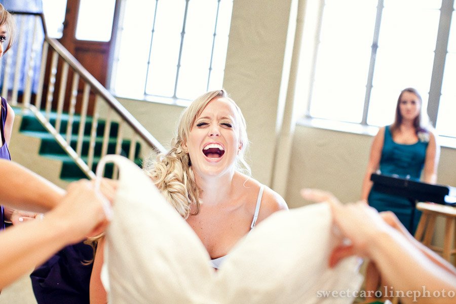Bride laughing and putting dress on at University United methodist church