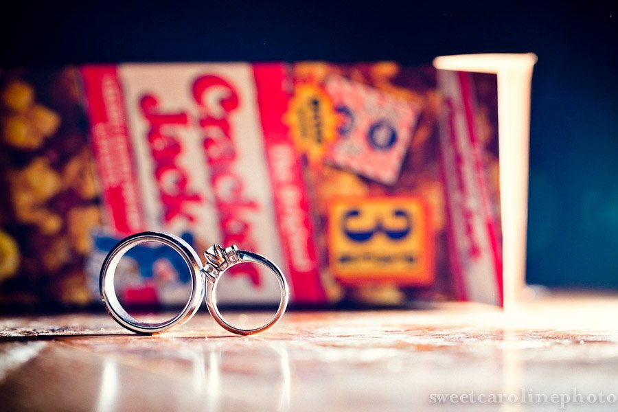wedding rings in front og cracker jacks box