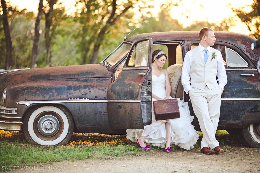 bride and groom by vintage car